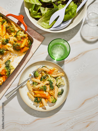 Broccoil mac and cheese pasta casserole with salad photo