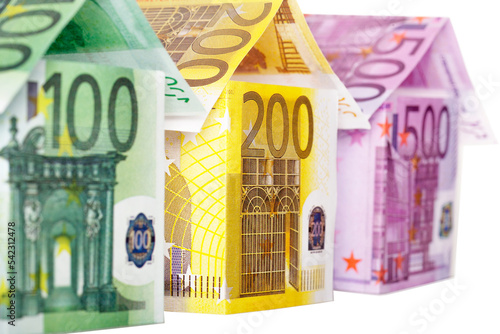 Three houses made of euro notes isolated on white background