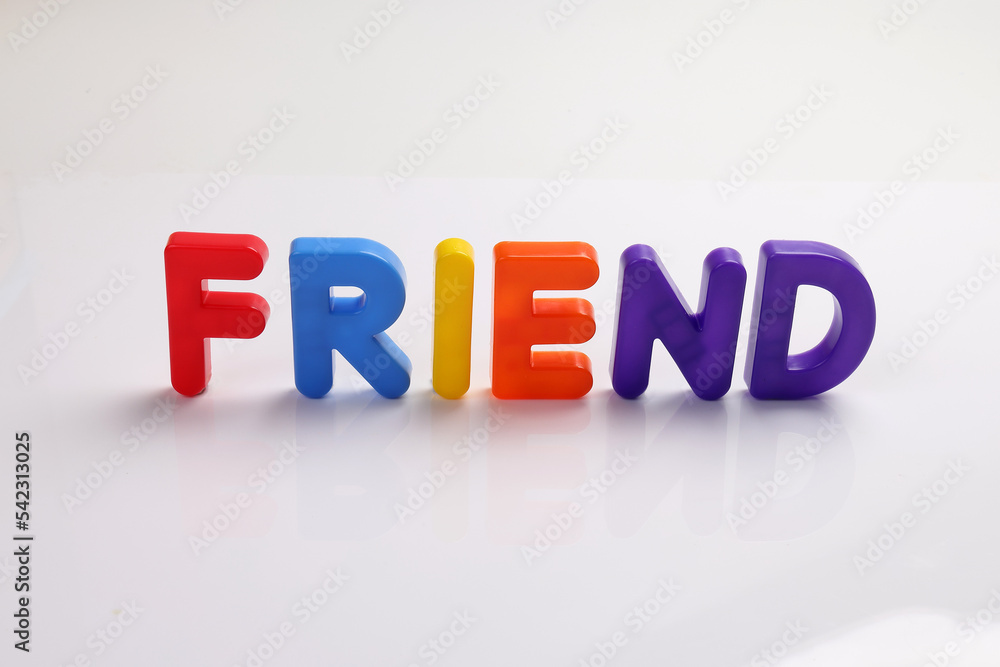 red green blue yellow plastic toy capital font letter alphabet friend on white background copy text space concept red green blue yellow plastic toy capital font letter alphabet friend on white background copy text space concept