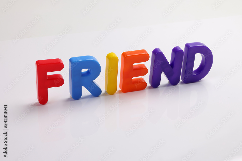 red green blue yellow plastic toy capital font letter alphabet friend on white background copy text space concept red green blue yellow plastic toy capital font letter alphabet friend on white background copy text space concept