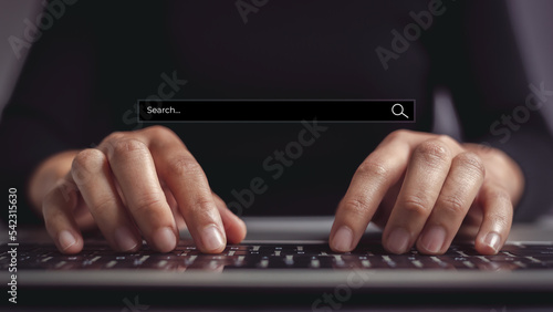 Female hand typing on laptop keyboard to search website. Concept of precisely finding exactly what the content is looking for and getting to top of search results.