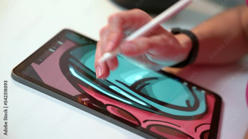 Hand draws pencil picture on tablet. Digital artist creates video game character, painting for