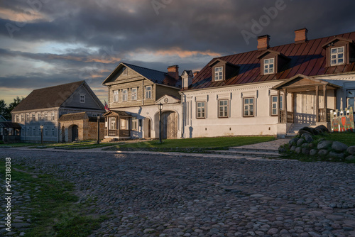 Fototapeta Naklejka Na Ścianę i Meble -  View of historical merchant buildings of estates on the main street of Izborsk Pechorskaya Street on a summer sunny day, Izborsk, Pskov region, Russia