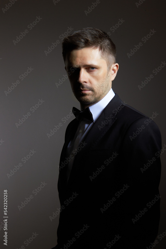 Man in black suite on black Man in black suite on black