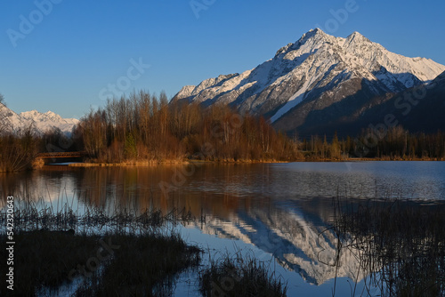 Snowy Pioneer Peak reflection in Reflections Lake, Alaska.