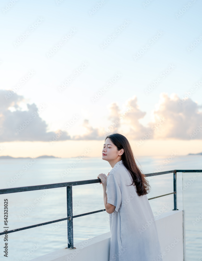 woman standing on the terrace by the sea