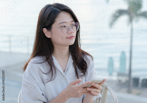 Woman sitting on terrace by the sea