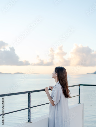 woman standing on the terrace by the sea