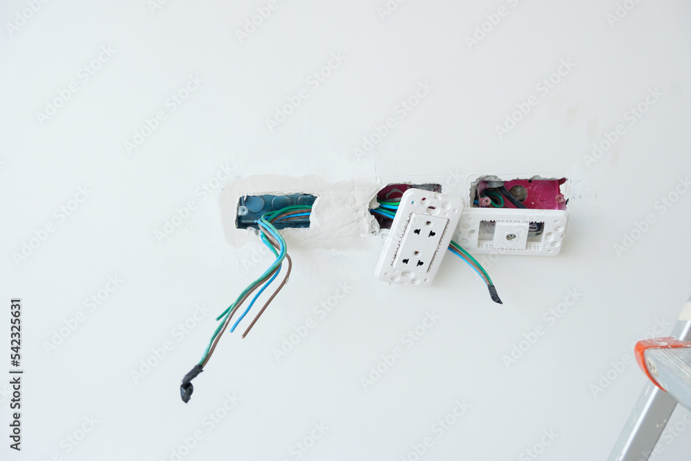 Electrical Wiring under plaster, hidden installation cables for socket to a concrete. Renovation, Repair and development of home and apartment concepts Electrical Wiring under plaster, hidden installation cables for socket to a concrete. Renovation, Repair and development of home and apartment concepts