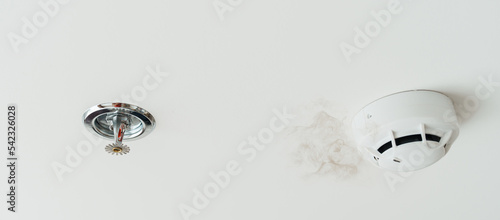 Fotografi Fire Sprinkler and Smoke sensor detector mounted on roof in home or apartment