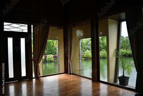 in a room with clear windows to the lake courtyard