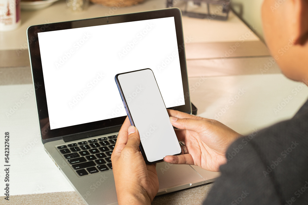 man using smart phone & laptop working at home man using smart phone & laptop working at home