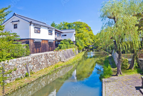 Canvas Print Japanese-style boat takes tourists around Hachiman-bori canal in Omihachiman town