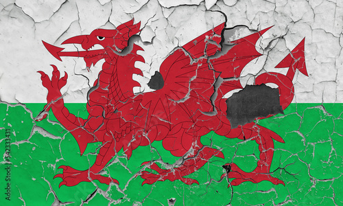 3D Flag of Wales on an old stone wall background.