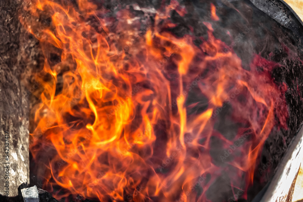 Burning fire in a barrel close-up. Bright flame. Open flame heating. Problems with heating and gas. Burning fire in a barrel close-up. Bright flame. Open flame heating. Problems with heating and gas.