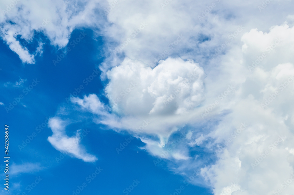 blue sky with clouds and white heart form