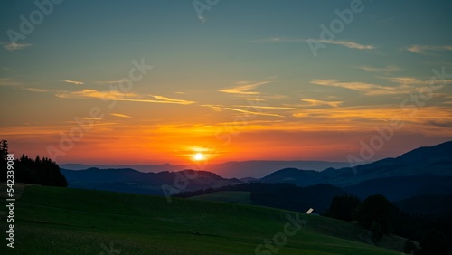 Beautiful shot of green field in mountains in the Black Forest, Germany at sunset