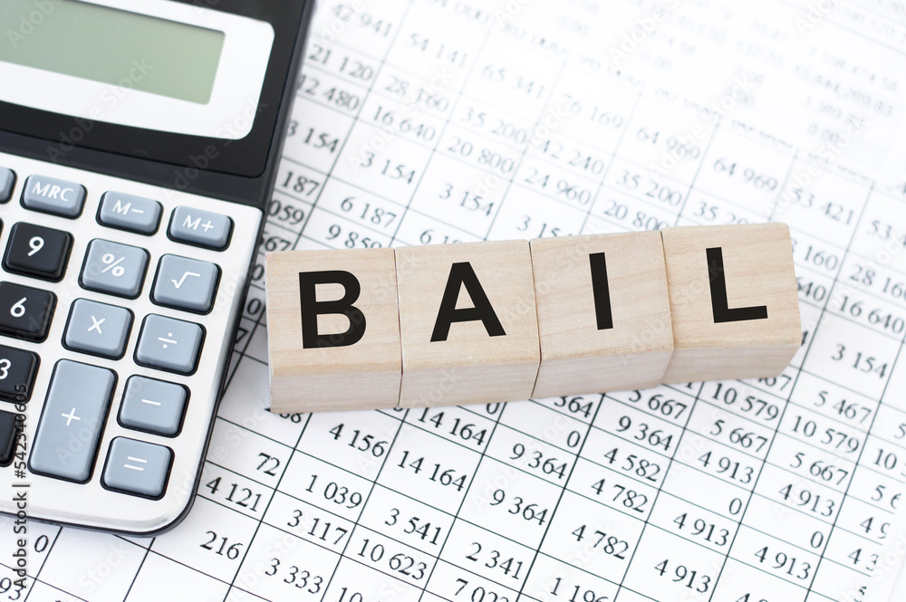 four wooden cubes with word BAIL on white working board. four wooden cubes with word BAIL on white working board.