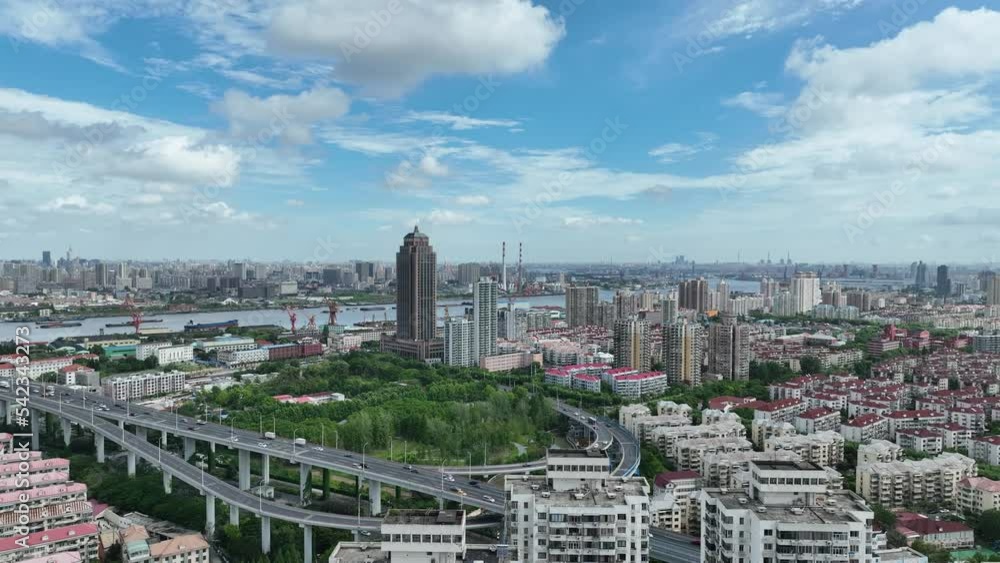 Buildings and highway in the city. Drone aerial view. Crowded apartment buildings in the city in a cloudy day.  Business, economy, real estate concept b-roll footage.