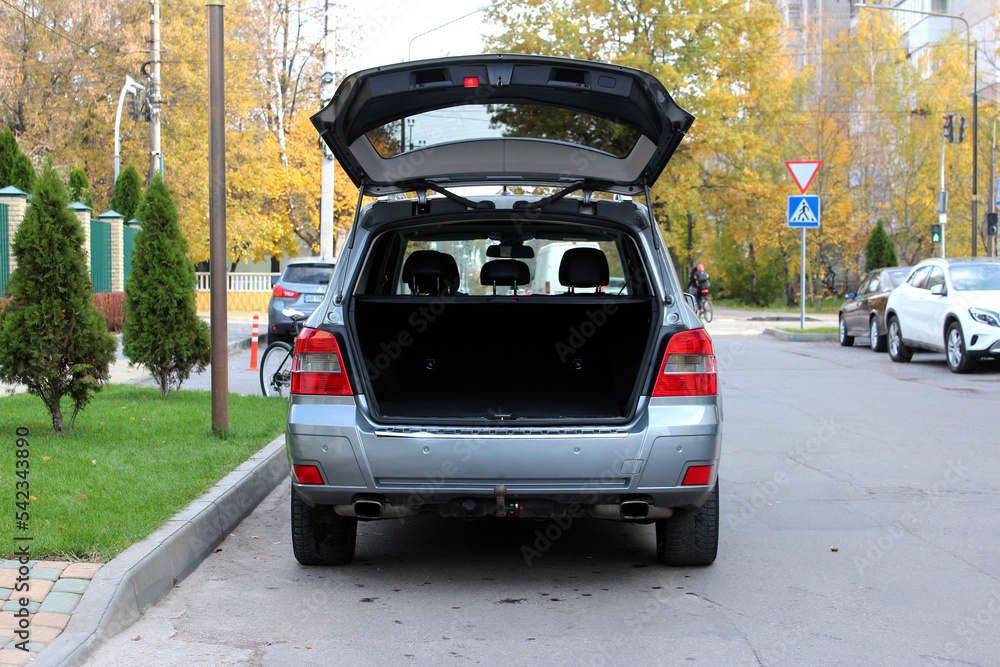 Modern car SUV with open empty trunk. Modern wagon car open trunk. Car boot is open.