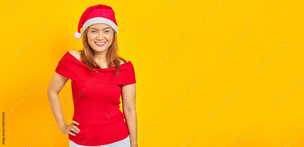 Portrait of cheerful young Asian woman holding hands over waist confident on yellow background Portrait of cheerful young Asian woman holding hands over waist confident on yellow background