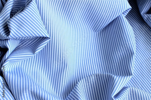 Blue and white striped fabric with pleats. Linen, silk or poplin.