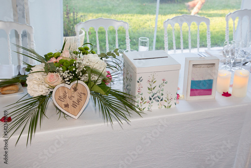 decorated wedding table with text french urn vive les maries means long live the bride and groom and sand box marked together forever in france ensemble pour toujours photo