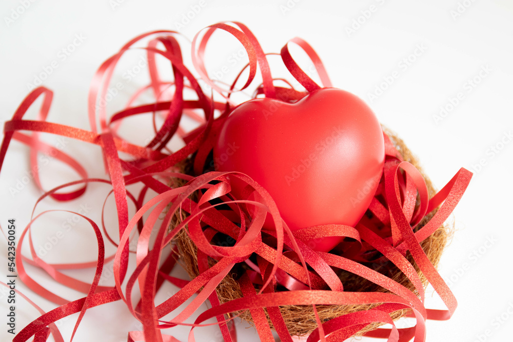 Close up red Heart bedded with red ribbon on white background Close up red Heart bedded with red ribbon on white background