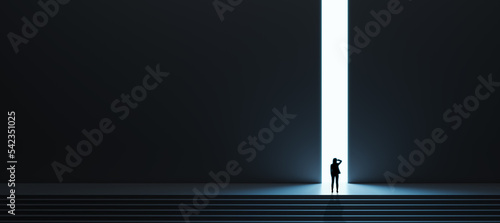 Dream, business success and opportunity concept with pensive woman in front of bright light hole in the wall of a huge dark hall with stairs