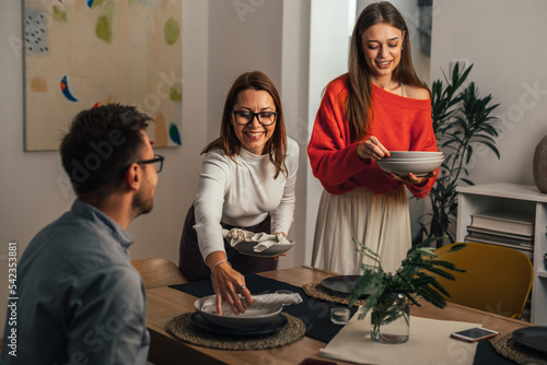Photography women serving dining table for dinner party at home