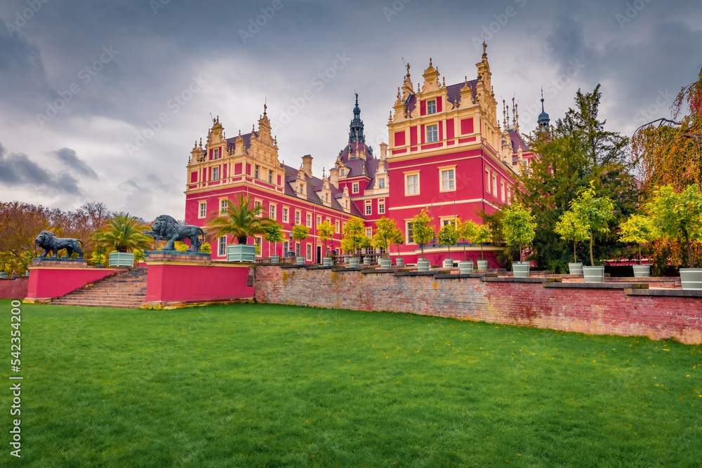 Fototapeta premium Spectacular autumn view of Muskau castle. Rainy morning scene in Muskau Park, UNESCO World Heritage Site, Upper Lusatia region, Saxony, Germany, Europe. Traveling concept background.