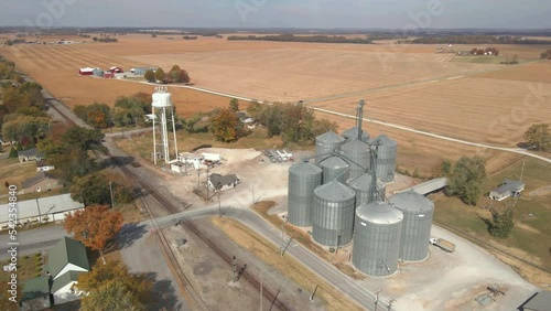 Orbit drone shot of huge steel barrels capacity modern silo granary for grain storage in a farm in Clarksville, tennessee photo