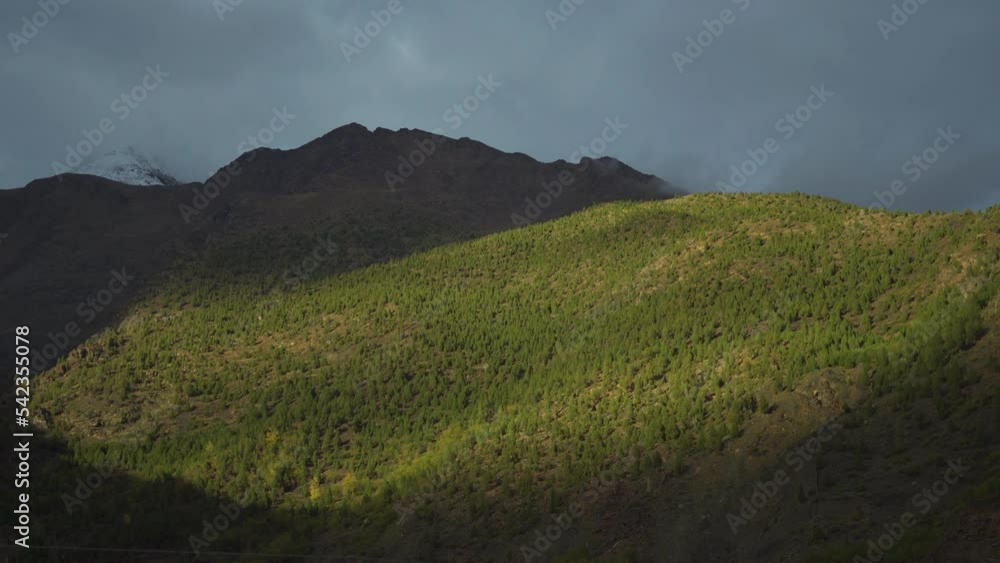 4K shot of sunlight slowly fading away from the mountain during the evening at Keylong in Himachal Pradesh, India. Sunlight slowly decreasing in intensity as sun goes behind the mountain peaks. 4K shot of sunlight slowly fading away from the mountain during the evening at Keylong in Himachal Pradesh, India. Sunlight slowly decreasing in intensity as sun goes behind the mountain peaks.