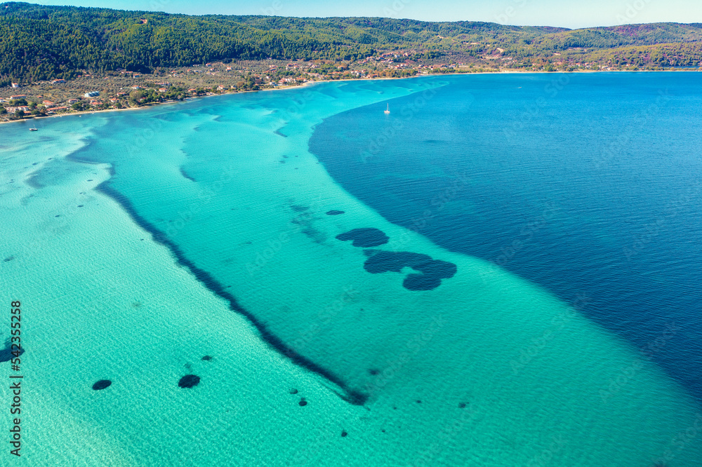 Seascape on a sunny day. View from above. Beautiful bay in Vourvourou, Halkidiki, Greece