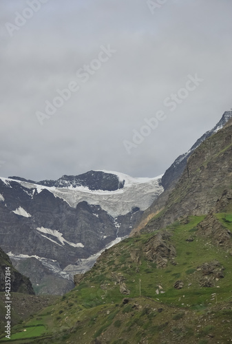 View of melting snow from rocky mountain during cloudy weather in Lahaul and Spiti, Himachal Pradesh, India. 
