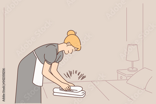 Housekeeper working in hotel room 