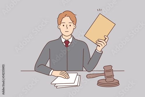 Male lawyer with documents sit at desk 