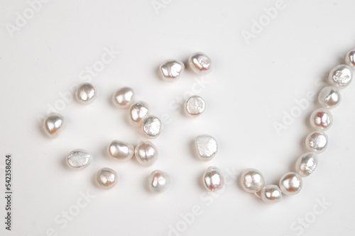 Baroque pearls strand. Natural freshwater pearl beads on white background. Top view