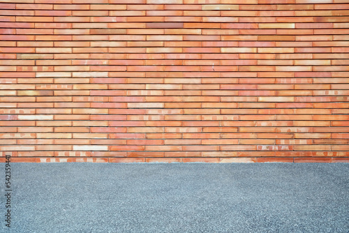 Red Brick Wall Background with Sand Pavement.