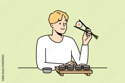 Smiling man sit at table in restaurant eating sushi with chopsticks. Happy guy enjoy traditional Asian food in cafe or bar. Vector illustration. 