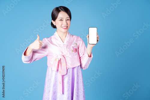 Image of young Korean woman wearing hanbok on background © Timeimage