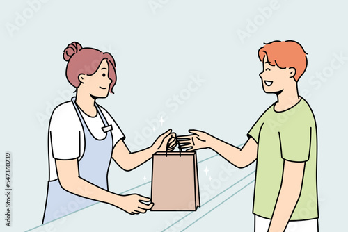 Smiling female cashier give cardboard bag to happy male customer in shop. Happy woman seller hand package to excited man client in store. Vector illustration. 