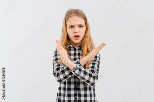 Dont like it. Upset teen girl shows stop, cross hands gesture, rejecting something, refusing and prohibiting, saying no, standing over white background.