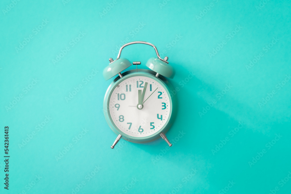 Blue alarm clock on blue background isolated, flat lay. Blue alarm clock on blue background isolated, flat lay.