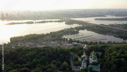 Aerial view of Kiev city scape with dnopro river. Evening sunset sky. photo