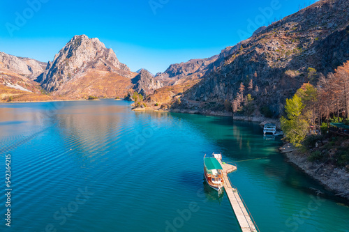 Green Canyon Turkey with tourist ship move on mountain lake, Aerial top view