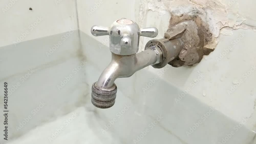 faucet water dripping in a white ceramic bathtub faucet water dripping in a white ceramic bathtub