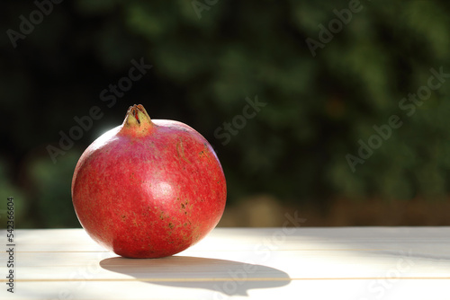 red ripe pomegranate on wooden background