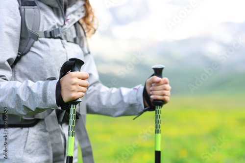 Hiker hands using poles in the mountain