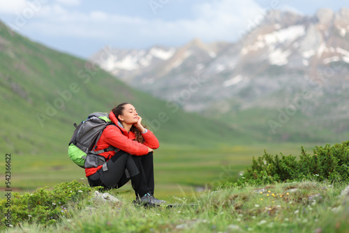 Hiker in red resting enjoying in the mountain
